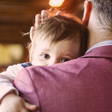 A child in his father's arms.